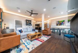 a living room with a couch and a table at Chic Downtown Retreat Fireplace Game Area in Hot Springs