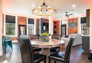 a dining room and living room with a table and chairs at Chic Downtown Retreat Fireplace Game Area in Hot Springs