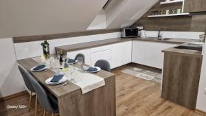 a kitchen with a table and chairs in a room at Apartmán Art in Zuberec