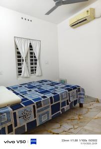 a bedroom with a blue and white bed in a room at JOHNs' Paradise - Homestay in Cochin