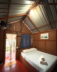 Ένα ή περισσότερα κρεβάτια σε δωμάτιο στο WimanAndaman วิมานอันดามัน ที่พัก -Koh Chang Ranong