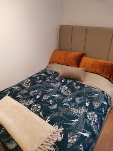 a bedroom with a bed with a blanket and pillows at Casa da Lara in Aveiro