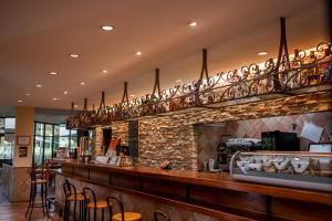 a bar in a restaurant with a stone wall at Hotel Baztan in Garzáin