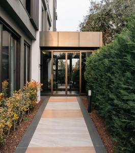 a walkway leading to a building with glass doors at Vesta Rooms in Antalya