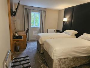 Ένα ή περισσότερα κρεβάτια σε δωμάτιο στο Wigan Oak Hotel