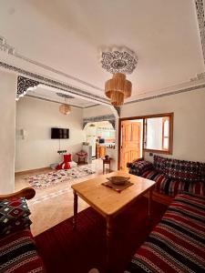 a living room with a couch and a table at Tayafut Apartments & Terrace by Surfleft Morocco in Mirleft +31 photos