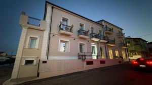 a building with a car parked in front of it at Antico Palazzo del Corso by Home Dardano in Mirto Crosia