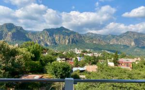 a view of a town with mountains in the background at Hotel Casa Maximiliano in Tepoztlán