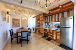 a kitchen with a table and a stainless steel refrigerator at Apartments Rux de Luxe in Bar