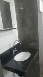 a bathroom with a black sink and a mirror at Studio Jaguary - Monte Verde in Camanducaia