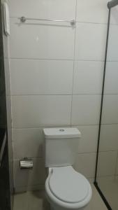 a bathroom with a white toilet in a stall at Studio Jaguary - Monte Verde in Camanducaia