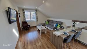 a living room with a couch and a table at Apartmán Art in Zuberec
