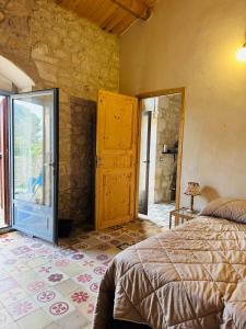 a bedroom with a bed and a glass door at Casa Betta in Modica