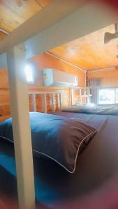 a bedroom with a bed in a wooden cabin at Stop by stay Pai in Pai