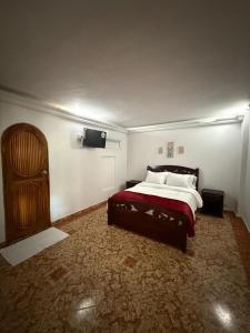 a bedroom with a bed and a tv on the wall at Hotel San Francisco Inn in Barranquilla +14 photos