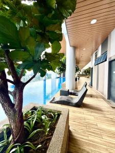 a building with a tree and a swimming pool at Infinitum Luxurious Sky Suites in Kuala Lumpur +43 photos