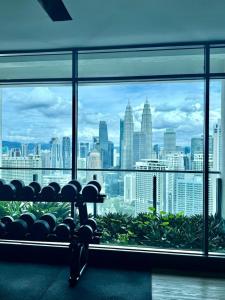 a room with a view of a city skyline at Infinitum Luxurious Sky Suites in Kuala Lumpur