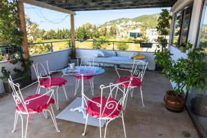 a patio with red chairs and a table on a balcony at Apartments Rux de Luxe in Bar