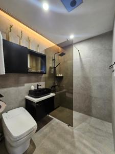 a bathroom with a toilet and a sink and a shower at 제주 이루후제 in Jeju