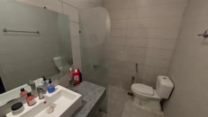 une salle de bain blanche avec toilettes et lavabo dans l'établissement Villa In Precinct 10a Bahria Town Karachi, à Karachi