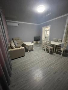 a living room with a couch and a table at Домик Zara in Samarkand