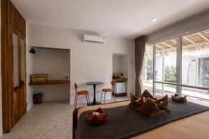 a bedroom with a bed with a large window at Sea Escapes Resort in Thongsala