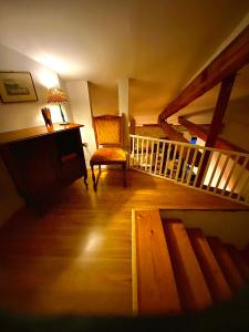 a living room with a staircase and a chair at Vojko Holidays in Koper