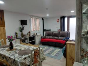 a living room with a table and a couch at Piedra Miranda in Vilaboa