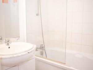 a white bathroom with a shower and a sink at Appartement Confortable 3 Pièces avec Piscine - 8 Personnes - Vignec Village, Proche Saint-Lary-Soulan - FR-1-504-18 in Vignec +13 photos