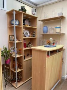 a kitchen with a counter and shelves with dishes at Pour une Escapade Urbaine in Blanquefort