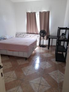 a bedroom with a bed and a tiled floor at Casa 6 in Olinda