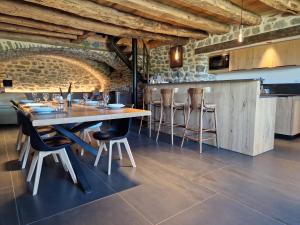 a dining room with a wooden table and chairs at Buron de Léon, en plein cœur de l Aubrac in Laguiole