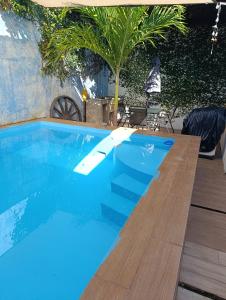 a swimming pool with blue water and a wooden deck at Casa Montiel in Mérida +13 photos