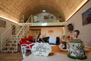 a room with a table with a bottle of wine at Il Risveglio nei Sassi in Matera