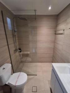 a bathroom with a shower and a toilet and a sink at City Loft in Sparta +22 photos