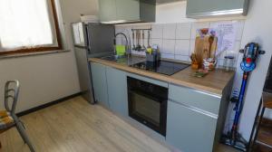 a kitchen with a sink and a stove top oven at SERRA E MESU Affittacamere in Magomadas
