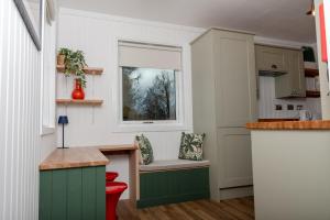 a kitchen with a bench in a tiny house at Highland Coo Lodge in Dunoon