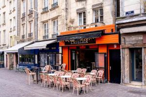 eine Gruppe von Tischen und Stühlen außerhalb eines Restaurants in der Unterkunft Le charme de la place Saint-Sauveur in Caen