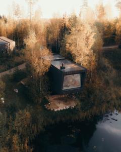 an aerial view of a house in a forest at Īves, Koka Maja in Amatciems