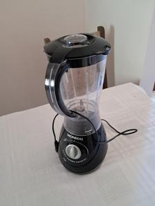 a black blender sitting on top of a table at kitnet Ceu in Campo Grande