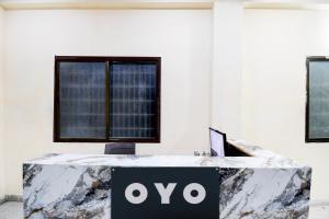 a table with an ovo sign on it in a room at SPOT ON The Royal Inn in Kakarmatha