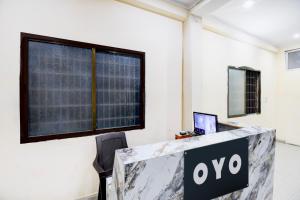 an office with a desk with a laptop on it at SPOT ON The Royal Inn in Kakarmatha