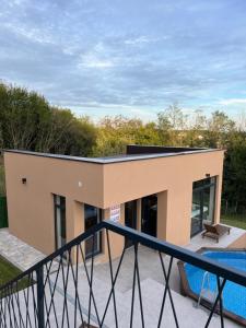 a house with a swimming pool and a balcony at Melody in Kapela