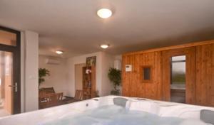 a large white bath tub in a room at Melody in Kapela