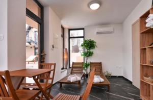 a dining room with chairs and a wooden table and a table and chairsktop at Melody in Kapela