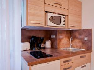 a kitchen with a sink and a microwave at Studio rénové au centre-ville avec balcon, parking et WIFI - 4 pers - FR-1-512-166 in Brides-les-Bains