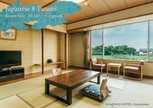 a living room with a table and a tv at KAMENOI HOTEL Yanagawa in Yanagawa +78 photos