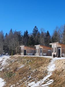 a couple of buildings sitting on top of a field at Auberge Les Enguenelles Lodges in Châtelblanc