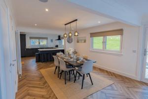 a dining room and kitchen with a table and chairs at The View at Portpatrick. in Portpatrick