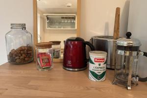 a counter with a coffee maker and other ingredients on it at Beautiful apartment of 67 m2 near Strasbourg in Bischheim +15 photos